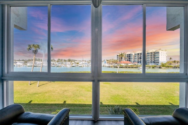 sunroom / solarium featuring a water view