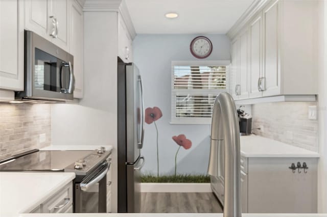 kitchen featuring appliances with stainless steel finishes, light countertops, and white cabinetry