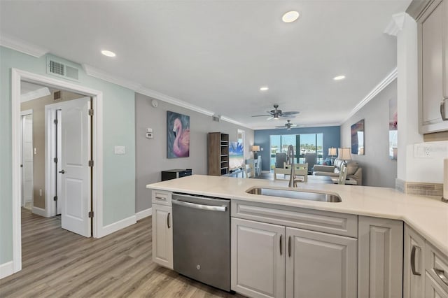 kitchen with visible vents, open floor plan, light countertops, stainless steel dishwasher, and a sink