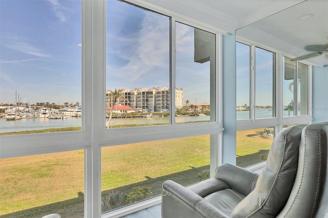 sunroom / solarium featuring a water view