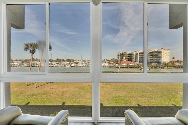 sunroom featuring a water view