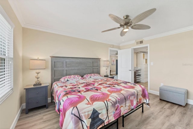 bedroom with baseboards, visible vents, light wood-style flooring, ceiling fan, and crown molding