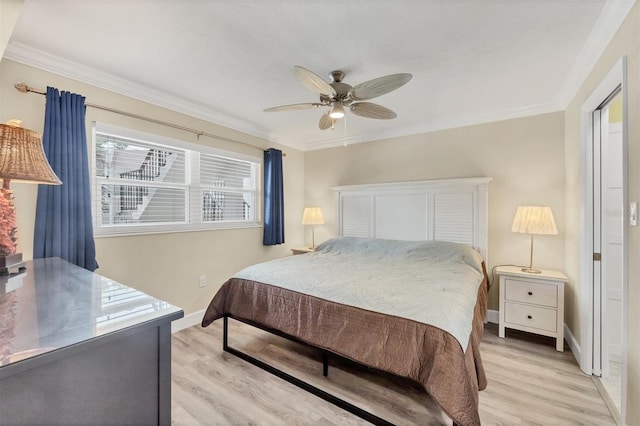 bedroom with ornamental molding, ceiling fan, light wood finished floors, and baseboards