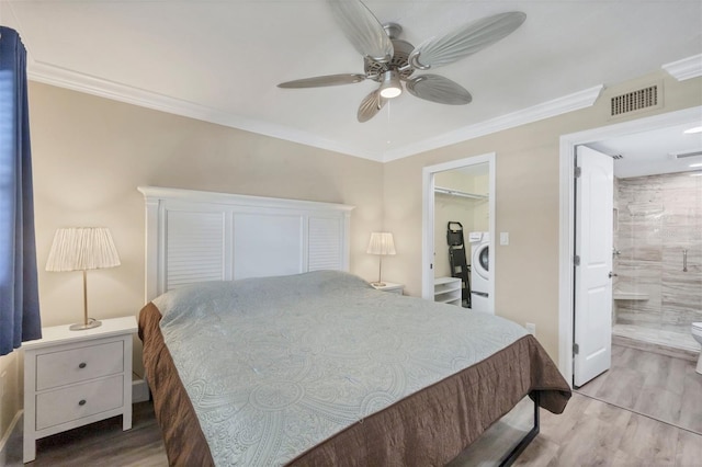 bedroom with visible vents, ornamental molding, a ceiling fan, washer / dryer, and light wood-type flooring