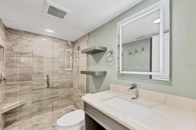 bathroom with toilet, a stall shower, visible vents, and vanity