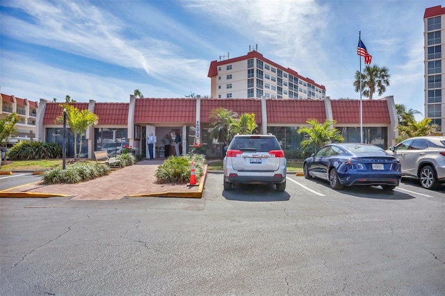 view of building exterior with uncovered parking