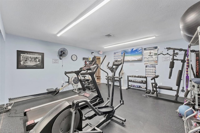 workout area with visible vents and a textured ceiling