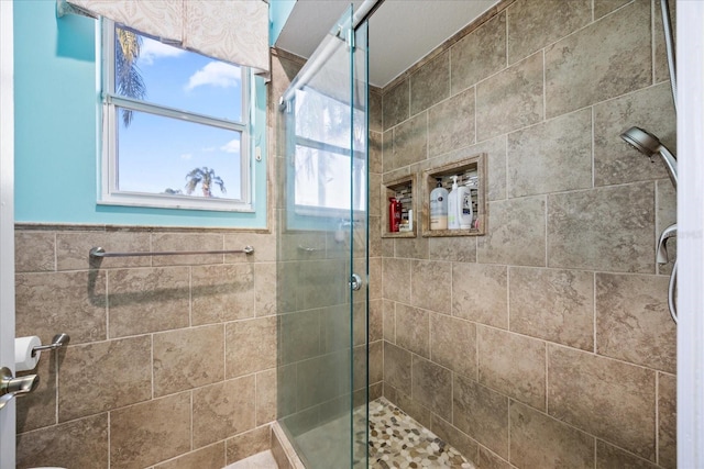 full bath featuring a shower stall