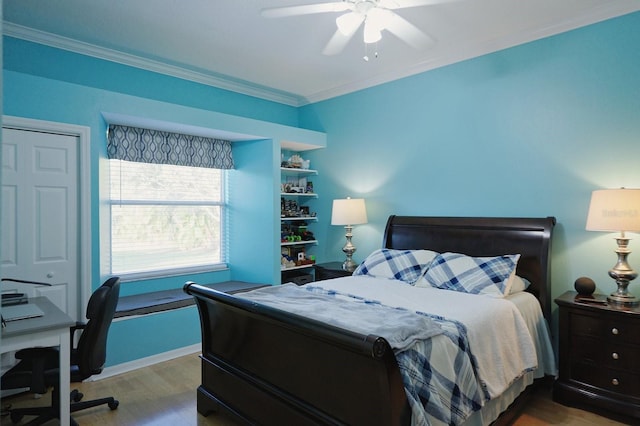 bedroom with wood finished floors, a ceiling fan, and crown molding