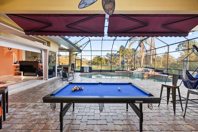 exterior space with a lanai, an outdoor pool, and an in ground hot tub