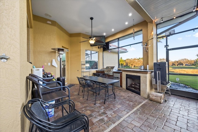 interior space featuring a ceiling fan and a tile fireplace