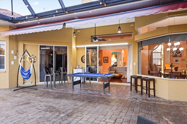 view of patio with glass enclosure and outdoor dry bar