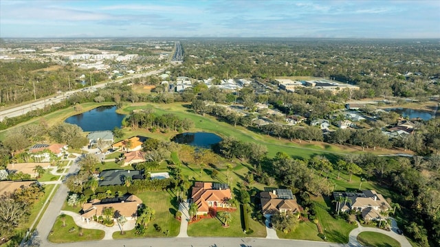 aerial view featuring golf course view, a water view, and a residential view