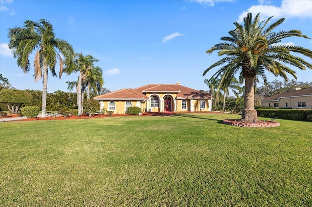 mediterranean / spanish-style house featuring a front lawn