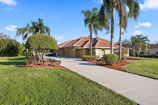 view of front of home featuring a tile roof, stucco siding, concrete driveway, a front yard, and a garage