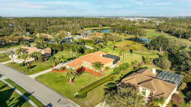 birds eye view of property with a water view and a forest view