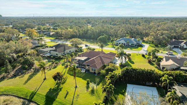 birds eye view of property with a residential view and a view of trees