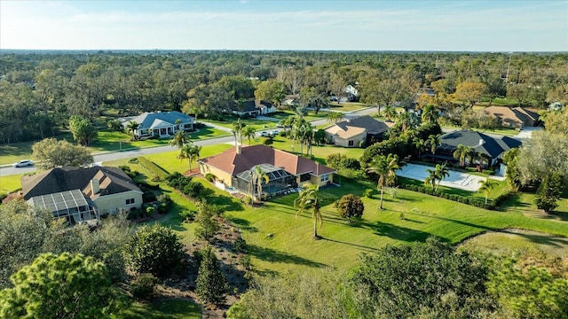 drone / aerial view with a residential view and a view of trees