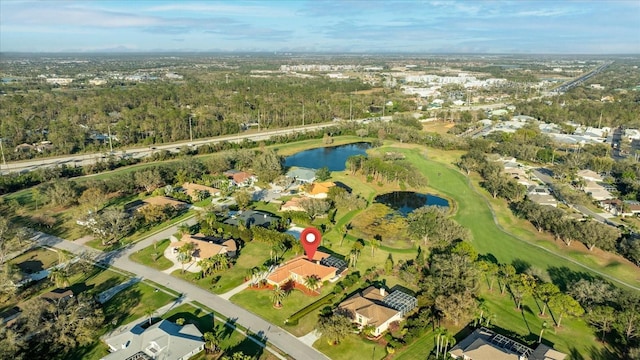 birds eye view of property featuring view of golf course and a water view