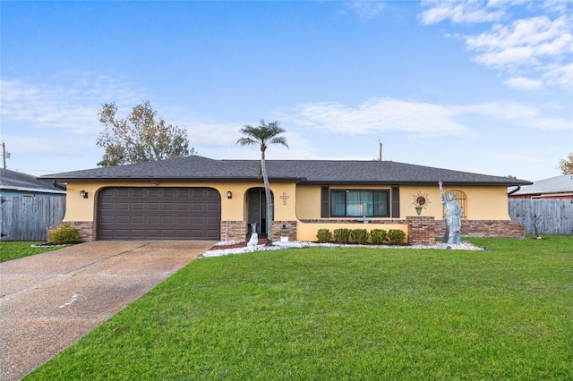 ranch-style home featuring a front yard, fence, concrete driveway, and stucco siding