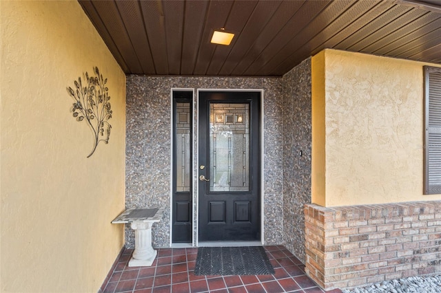 doorway to property featuring stucco siding