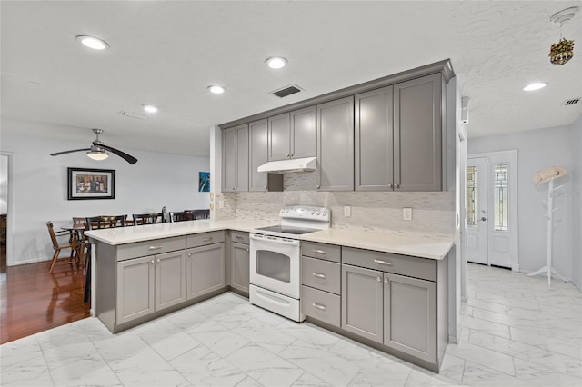 kitchen with marble finish floor, visible vents, white electric range, gray cabinetry, and under cabinet range hood