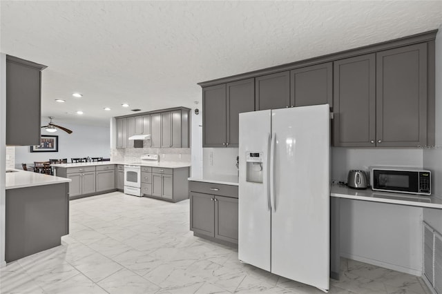 kitchen with marble finish floor, light countertops, gray cabinetry, a ceiling fan, and white appliances