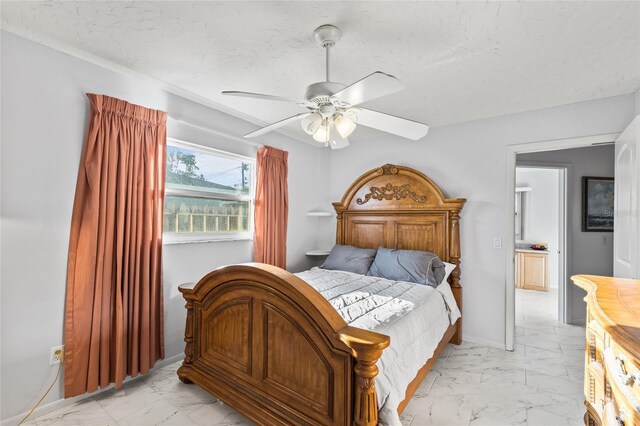 bedroom with a textured ceiling, marble finish floor, a ceiling fan, and baseboards