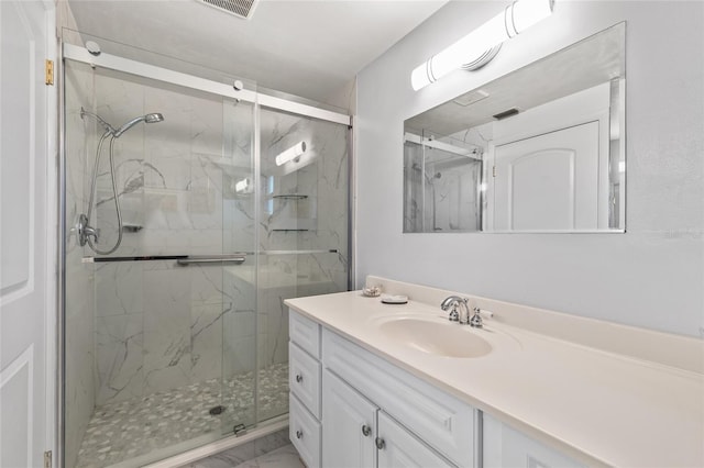 bathroom with visible vents, marble finish floor, a marble finish shower, and vanity