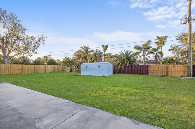 view of yard featuring a fenced backyard, an outdoor structure, and a storage unit