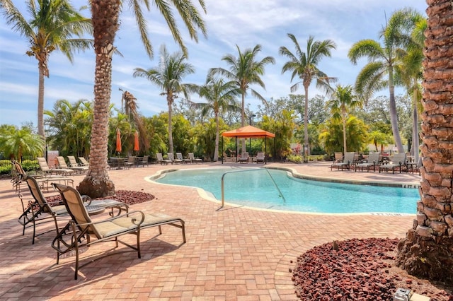 community pool with a patio and a gazebo