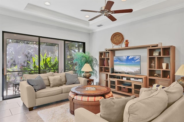 living area with light tile patterned floors, ornamental molding, a raised ceiling, and visible vents