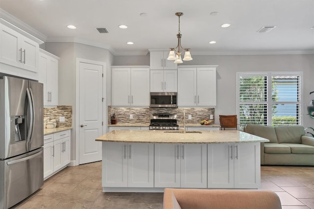 kitchen with stainless steel appliances, pendant lighting, white cabinets, and visible vents