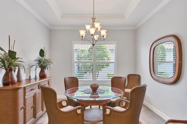 dining area with a raised ceiling, a notable chandelier, and baseboards