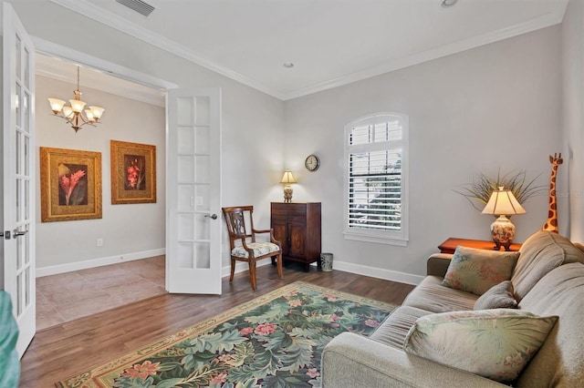 living area featuring ornamental molding, french doors, and wood finished floors