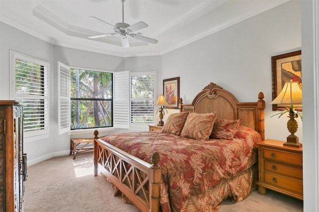 bedroom featuring a raised ceiling, light colored carpet, crown molding, and baseboards