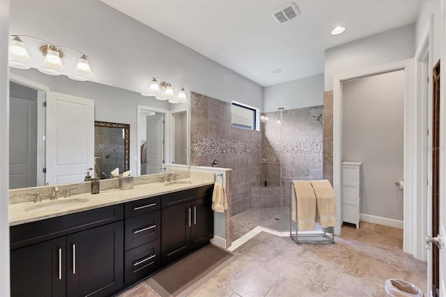 full bathroom with double vanity, walk in shower, a sink, and visible vents