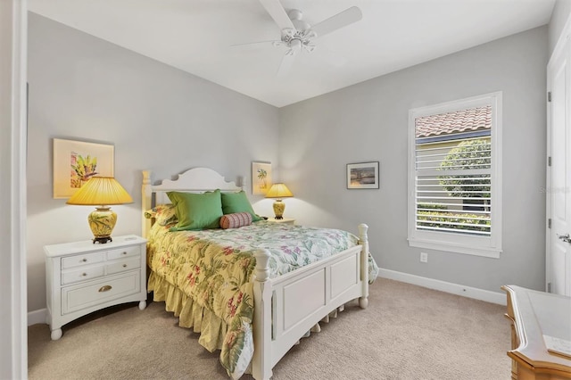 bedroom with baseboards, ceiling fan, and light colored carpet