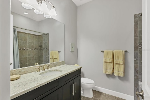 bathroom featuring baseboards, tiled shower, toilet, tile patterned flooring, and vanity