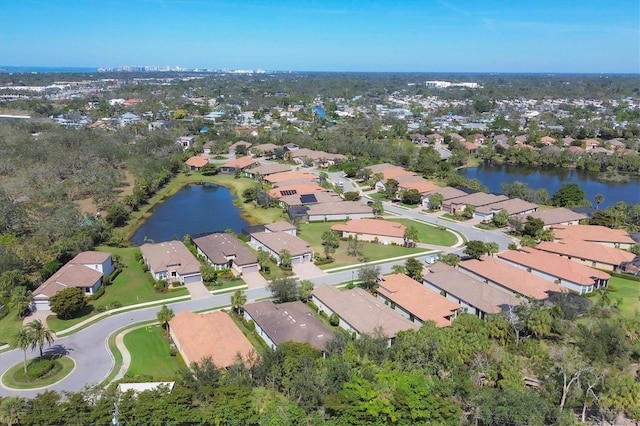 drone / aerial view featuring a residential view and a water view