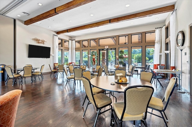 dining area with baseboards, dark wood finished floors, a high ceiling, beam ceiling, and recessed lighting