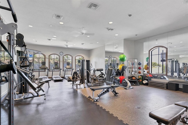 workout area featuring visible vents, a textured ceiling, and recessed lighting