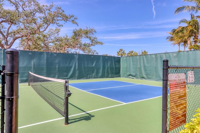 view of tennis court with fence