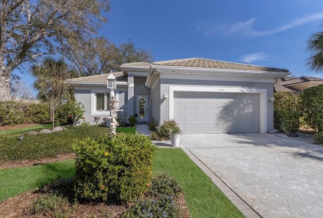 view of front of home with a garage, driveway, a tile roof, and stucco siding