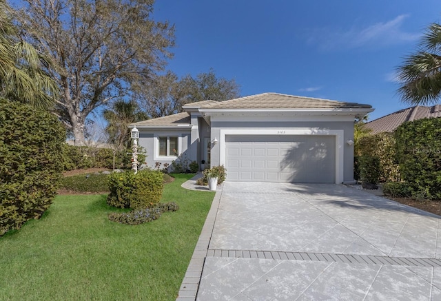 ranch-style house with a garage, stucco siding, concrete driveway, and a front yard