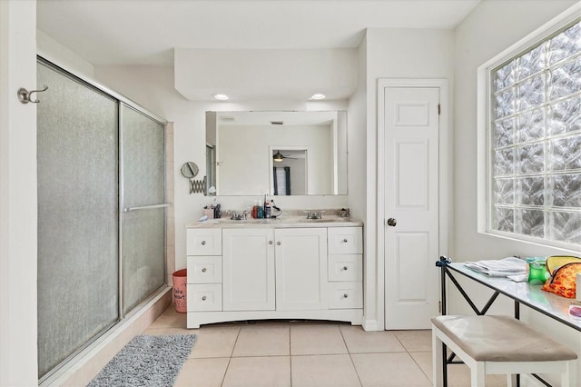 bathroom featuring a stall shower, tile patterned flooring, and vanity