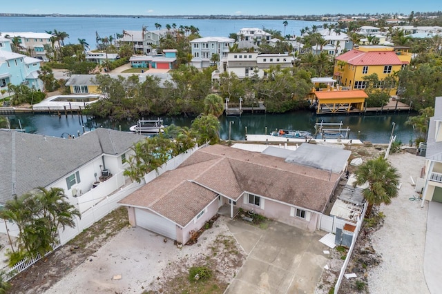 drone / aerial view featuring a residential view and a water view