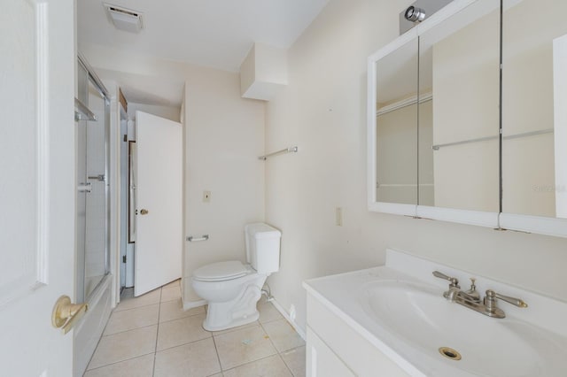 full bath featuring toilet, vanity, visible vents, and tile patterned floors