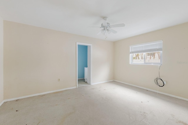 empty room featuring carpet floors, ceiling fan, and baseboards