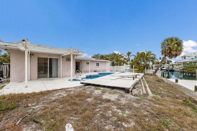 exterior space featuring a fenced in pool, stucco siding, a patio area, fence, and a pergola